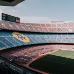 View of Camp Nou stadium in Barcelona, showcasing the iconic stands and field.