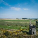Aerial view of Wheal Betsy mining ruins amidst the scenic landscapes of Dartmoor, England.