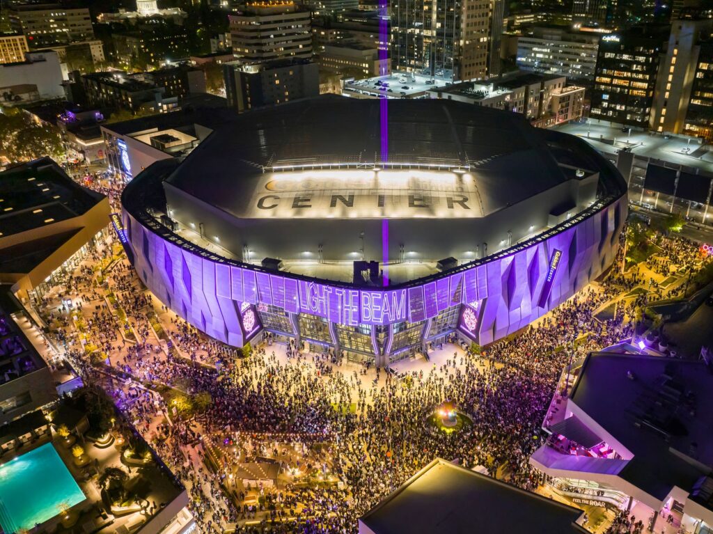 Vibrant aerial night view of a crowded stadium with illuminated surroundings in Sacramento, California.