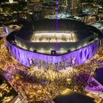 Vibrant aerial night view of a crowded stadium with illuminated surroundings in Sacramento, California.