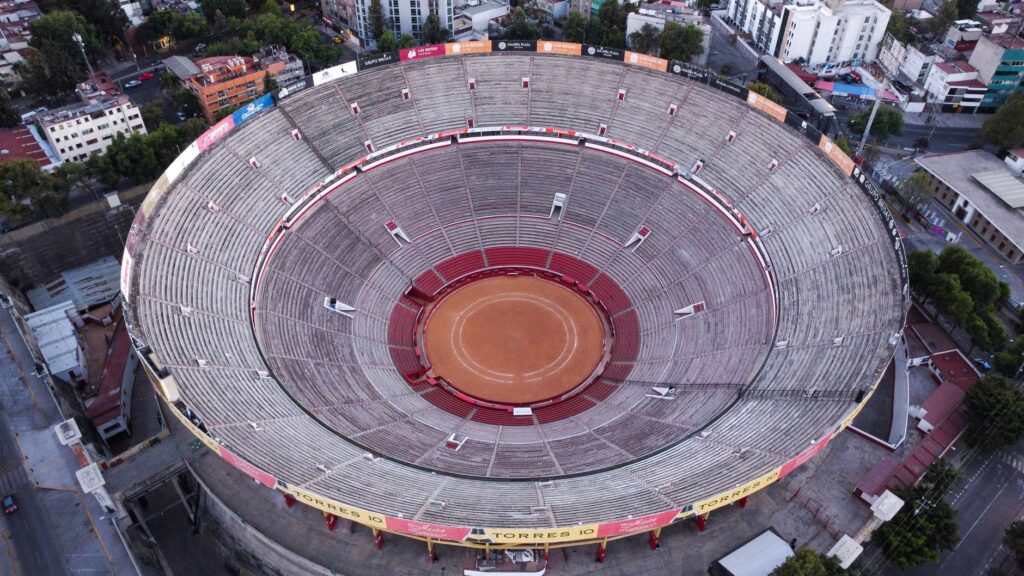 Drone shot capturing the circular bullring stadium in Mexico City from above, showcasing its architecture.