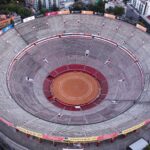 Drone shot capturing the circular bullring stadium in Mexico City from above, showcasing its architecture.
