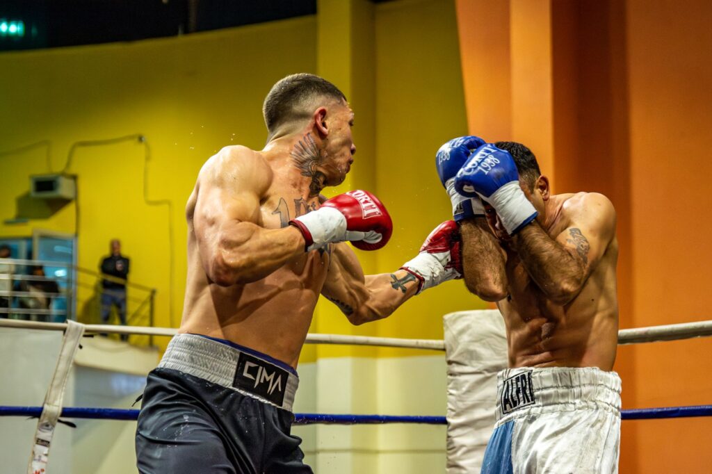 Two boxers in a high-energy match inside an arena showcasing intense combat and skill.