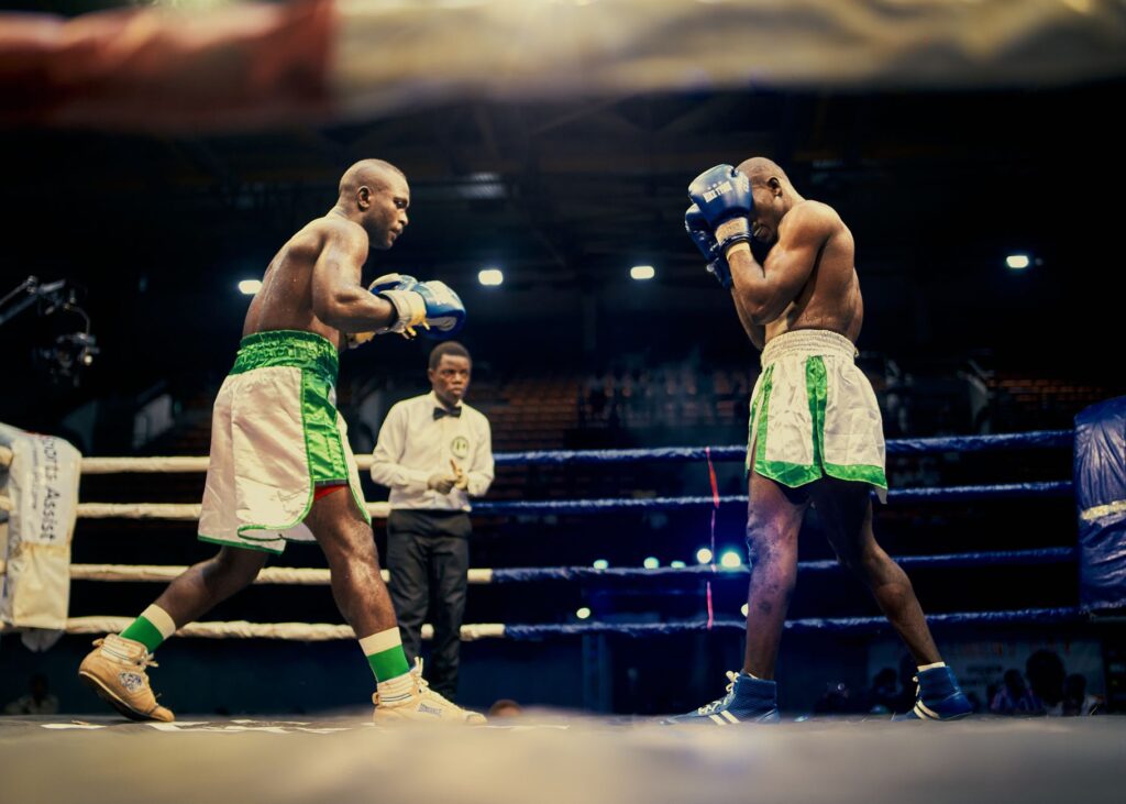 Two boxers engaged in a competitive match in Lagos, Nigeria boxing ring.