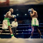 Two boxers engaged in a competitive match in Lagos, Nigeria boxing ring.