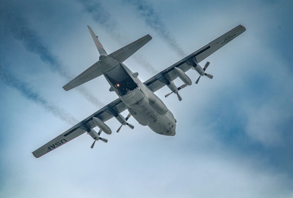 USAF C-130 Hercules ascending, showcasing aerodynamics and power in the sky.