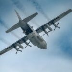 USAF C-130 Hercules ascending, showcasing aerodynamics and power in the sky.