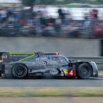 Dynamic shot of a racing car speeding on the Le Mans circuit, capturing the essence of endurance racing.