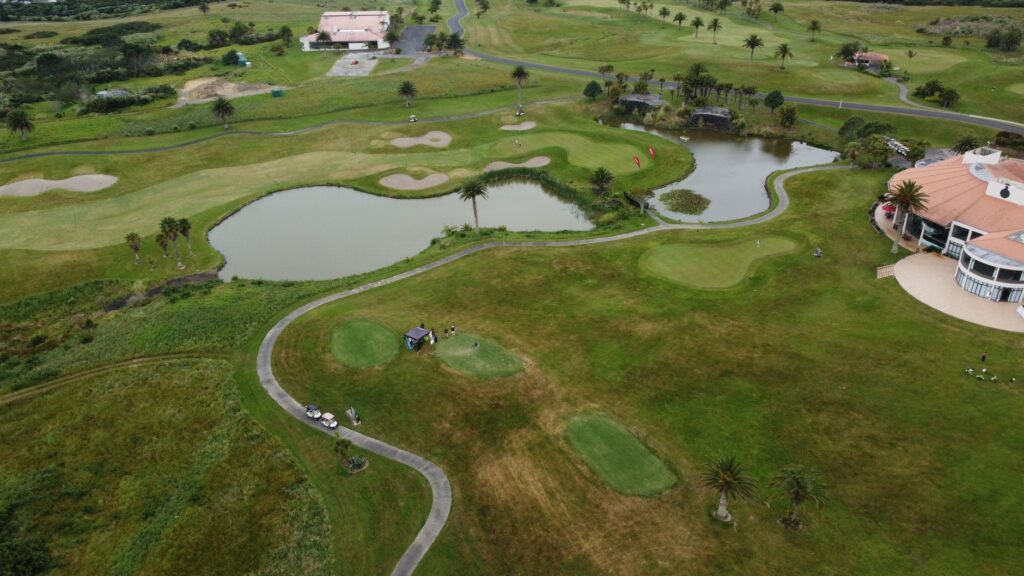 Scenic aerial image of a beautiful golf course in Auckland, New Zealand, ideal for sports and nature enthusiasts.
