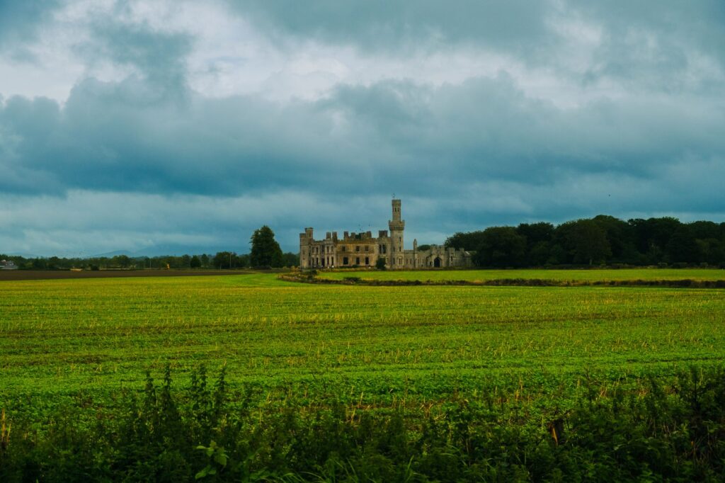 Scenic view of Duckett's Grove surrounded by lush countryside and dramatic skies in Carlow, Ireland.