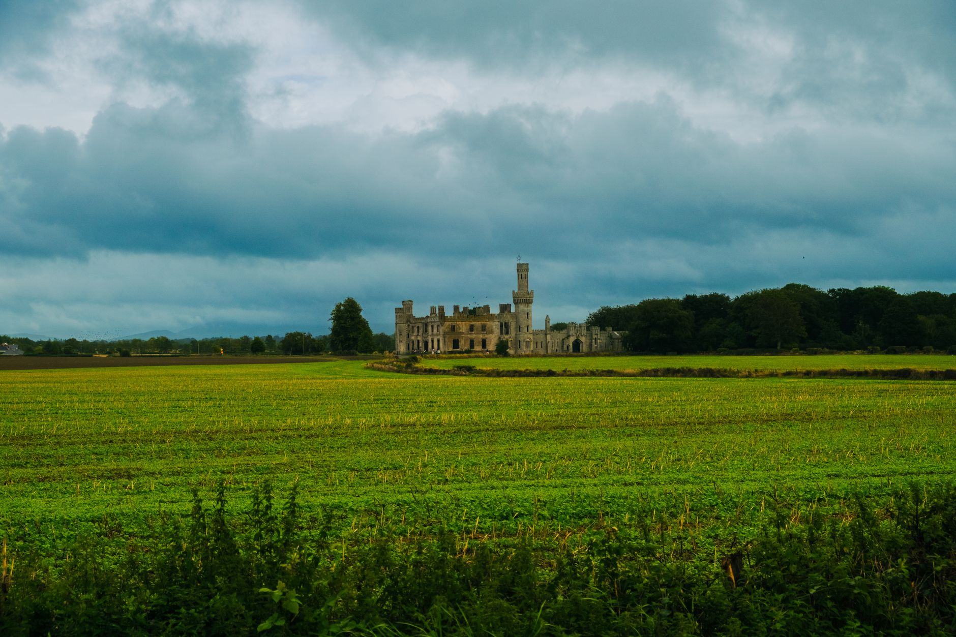 Scenic view of Duckett's Grove surrounded by lush countryside and dramatic skies in Carlow, Ireland.