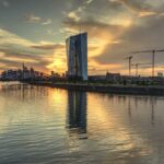 Stunning view of the Frankfurt skyline and ECB building during sunset reflecting on the Main River.