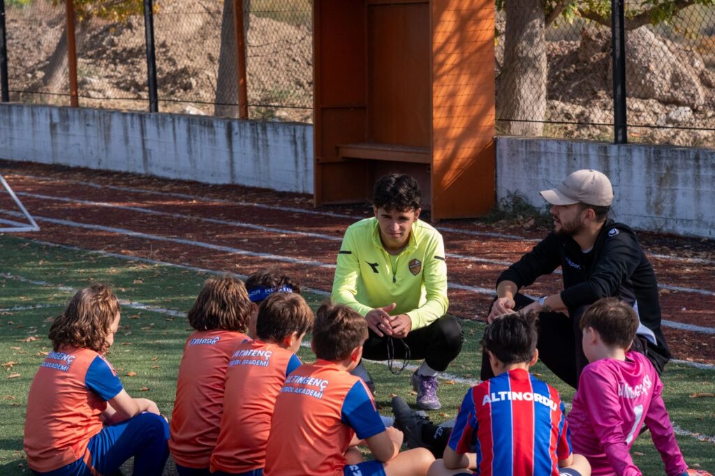 Group of kids and coaches during a youth soccer training session outdoors in İzmir, Turkey.