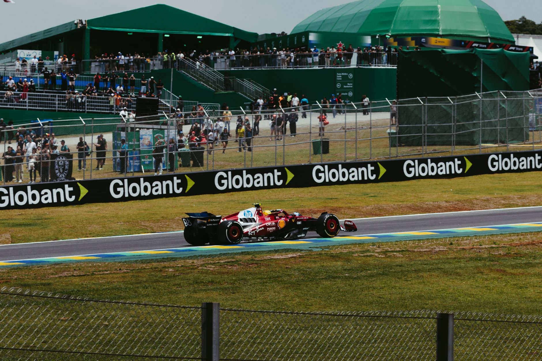 Exciting Formula 1 race action with Ferrari car at Interlagos, São Paulo, Brazil.