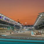Formula 1 race event at Yas Marina Circuit, Abu Dhabi during sunset.