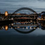 Stunning night cityscape of Newcastle's Tyne Bridge reflecting in the river.