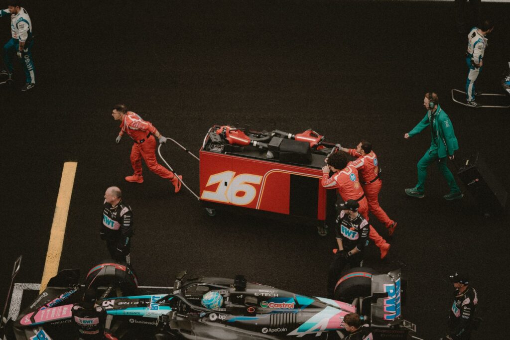 Dynamic shot of a pit crew working during a race event, showcasing teamwork and coordination.