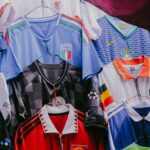 Various vintage soccer jerseys hanging on display, showcasing international teams' designs.