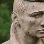 Close-up of a stone sculpture at a cemetery in Augsburg, Germany.