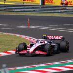 Dynamic shot of a Formula 1 car speeding around a corner at Hungaroring, Mogyoród.