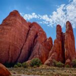 Stunning red rock formations under a bright blue sky in Emery County, Utah.