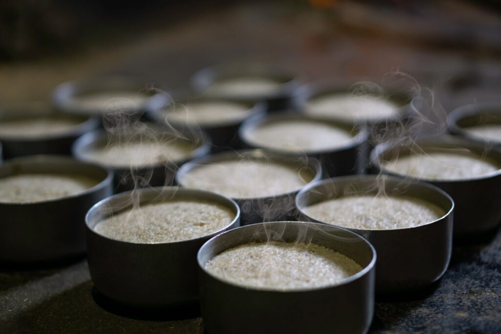 Steaming hot rice cakes in traditional bowls, capturing Indian culinary essence.