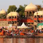 Bustling evening at Ram Ghat with pilgrims and vibrant architecture in Ujjain, India.