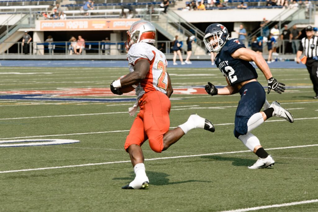 Action-packed scene of players competing in an American football game in a Toronto stadium.