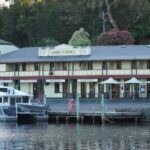 Hamers Hotel with boats docked on the scenic waterfront in Strahan, Tasmania.