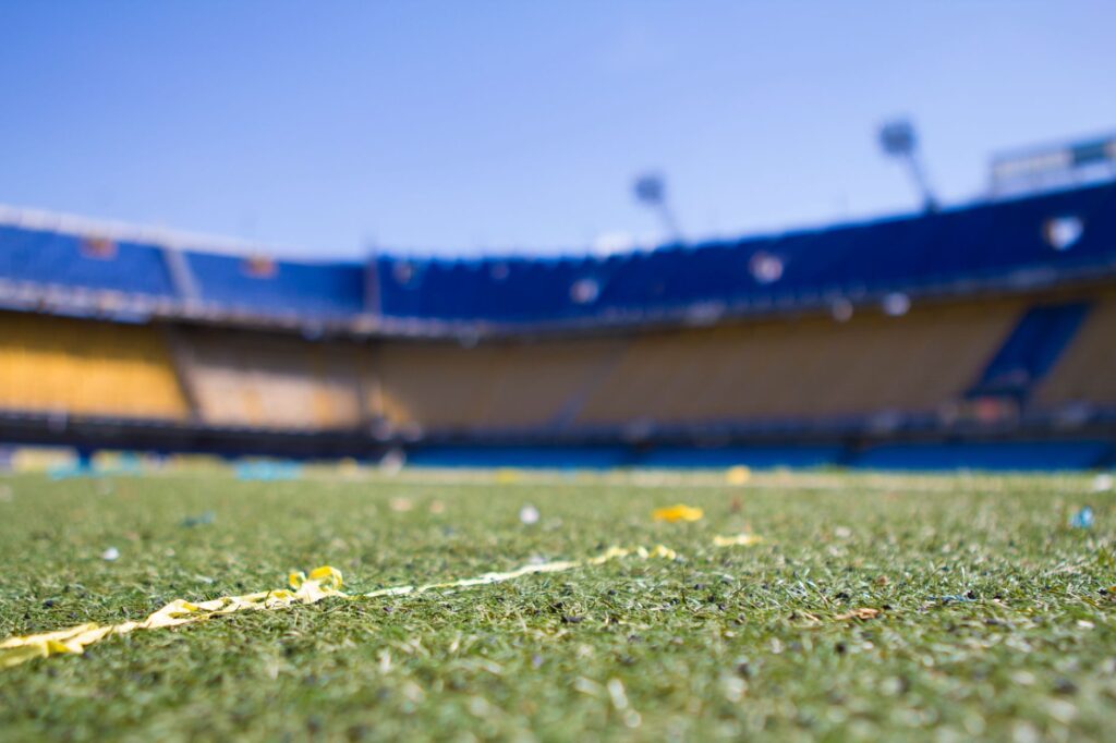 Close-up view of a vibrant football pitch in a sunlit Buenos Aires stadium, perfect for sports enthusiasts.