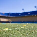 Close-up view of a vibrant football pitch in a sunlit Buenos Aires stadium, perfect for sports enthusiasts.
