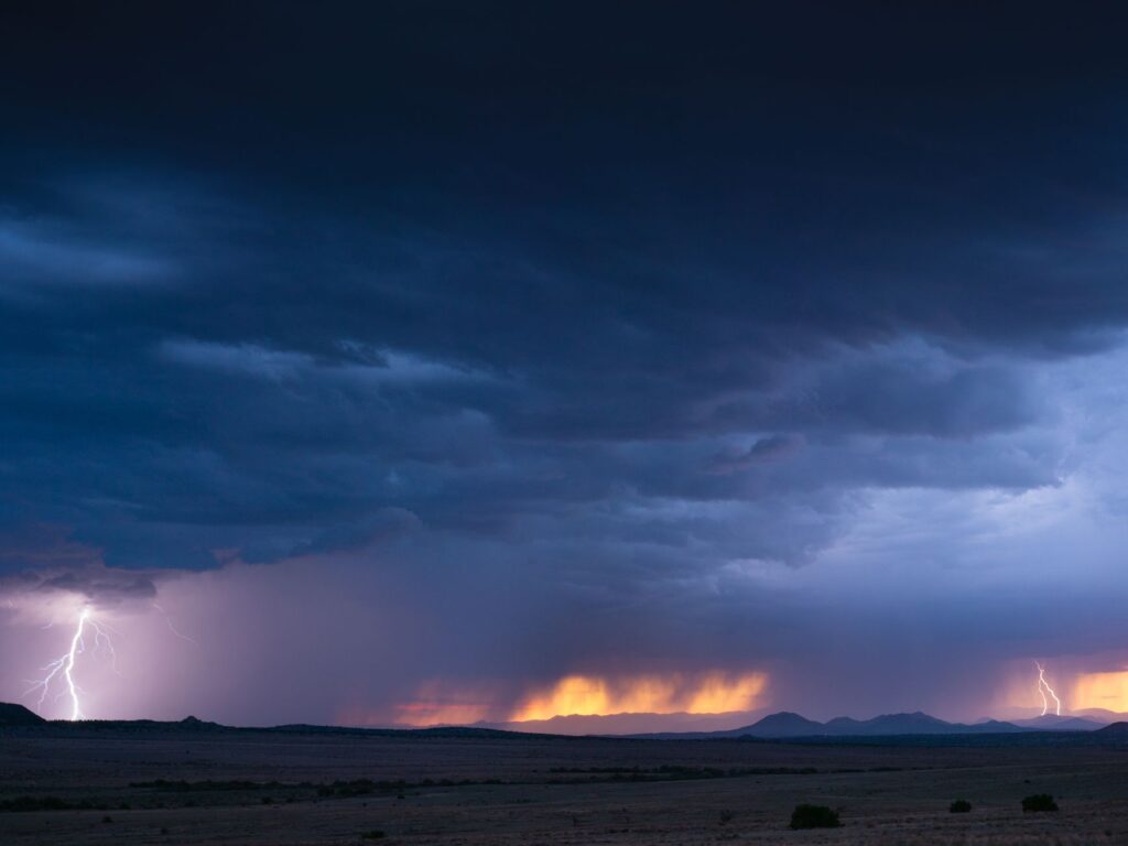 Captivating view of lightning strikes during a thunderstorm in New Mexico, showcasing vibrant skies.