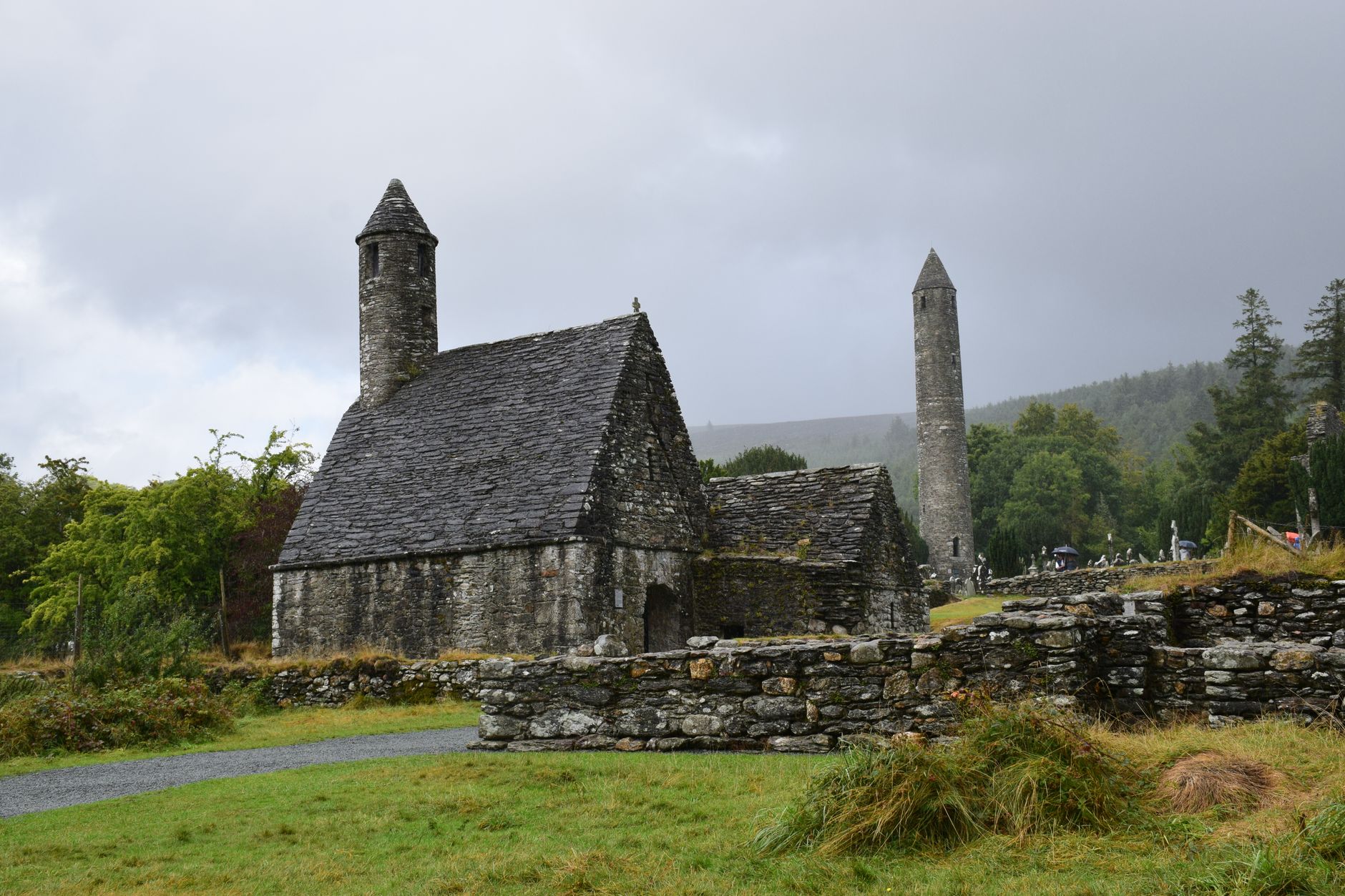 A serene view of the ancient St. Kevin's Church against an overcast sky in Glendalough, Ireland.