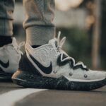 Stylish Nike sneakers on an asphalt road, perfect for sports and casual wear.