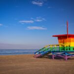 Colorful rainbow lifeguard tower on the sandy shores of Santa Monica Beach, Los Angeles, CA.