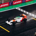 A classic Formula One car races on a wet track, capturing the thrill of motorsport.