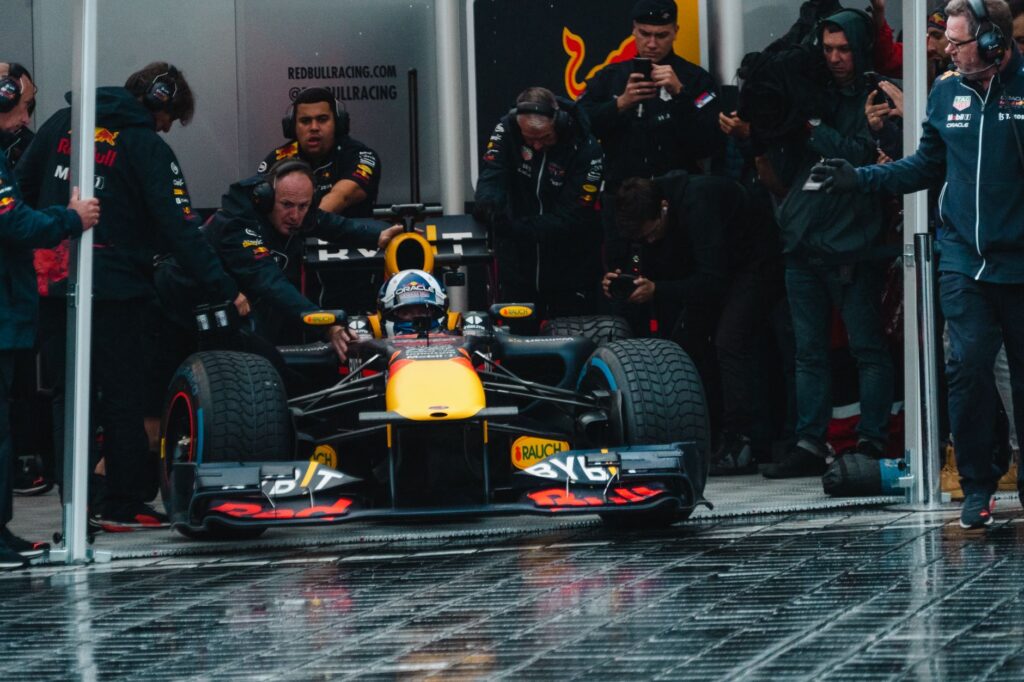 Exciting Formula One car during a dynamic pit stop, showcasing teamwork and precision.