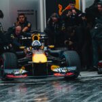 Exciting Formula One car during a dynamic pit stop, showcasing teamwork and precision.
