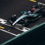 Top view of a Formula One car crossing the finish line in a high-speed race.