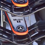 Detailed view of a Formula 1 car's front wing with Mercedes-Benz logos at Indianapolis.