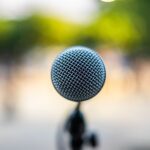Soft focus of modern microphone located on stage during music concert in park