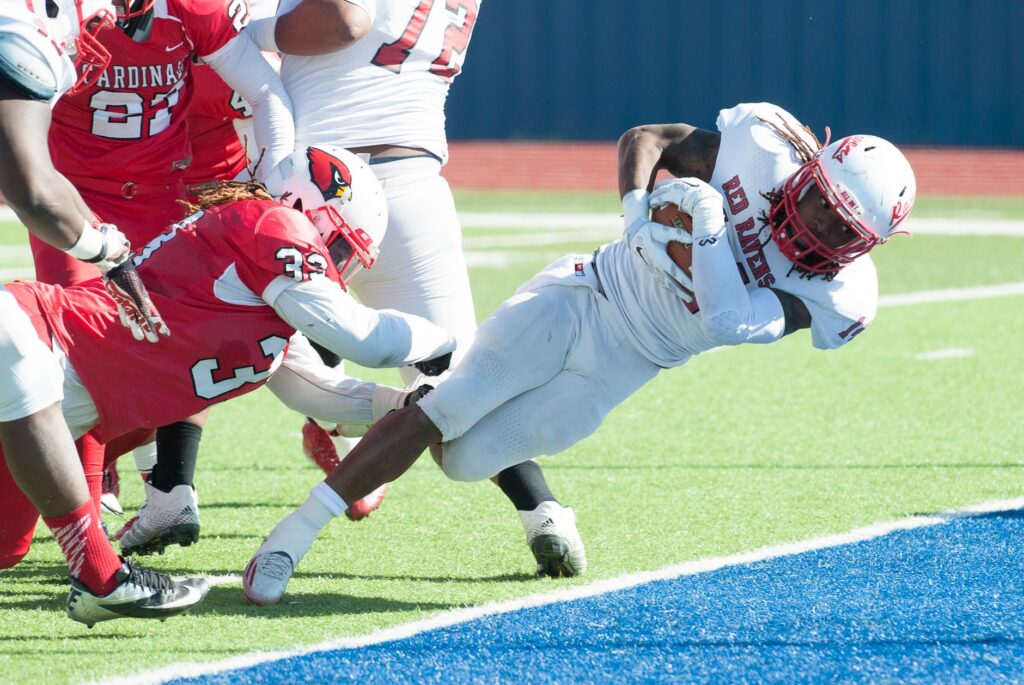 Dynamic scene of American football players in an intense play on the field.