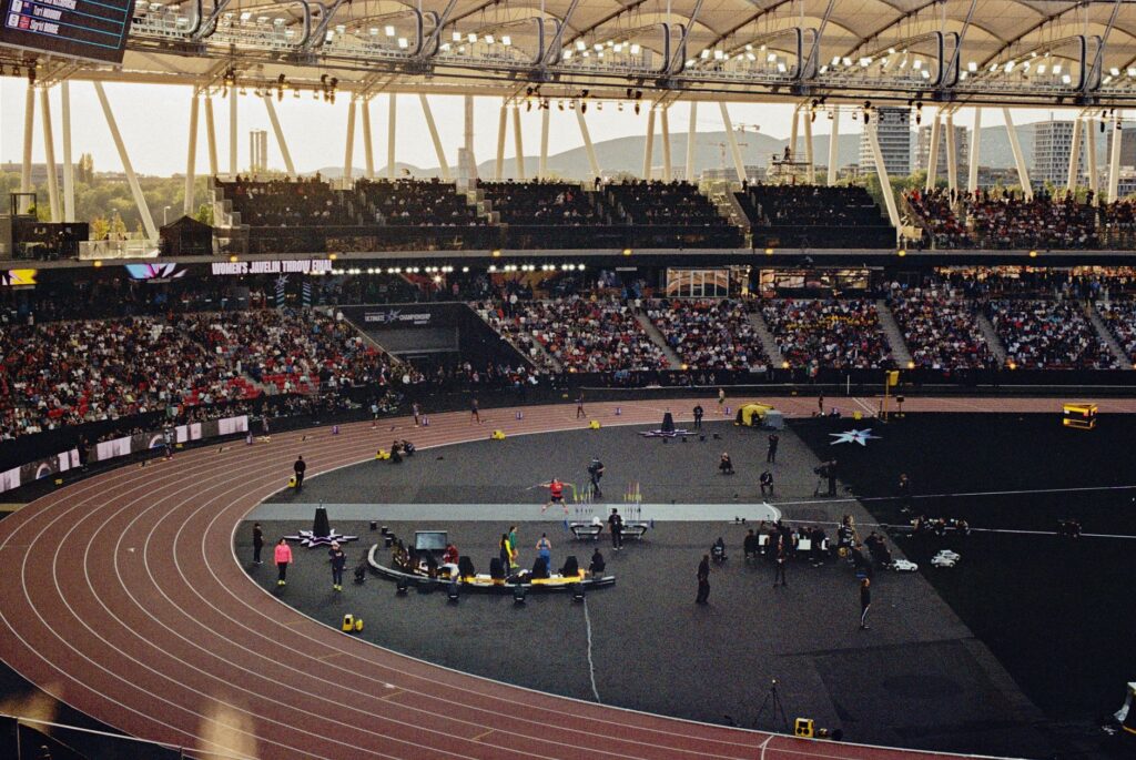 Packed arena scene showcasing a thrilling javelin event under twilight skies.