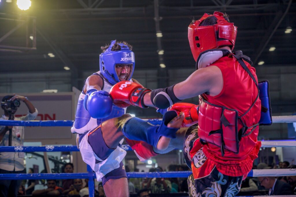 Dynamic kickboxing match capturing action and intensity between fighters in Kolkata, India.