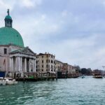Explore the stunning architecture along Venice's Grand Canal with its iconic dome and boats.