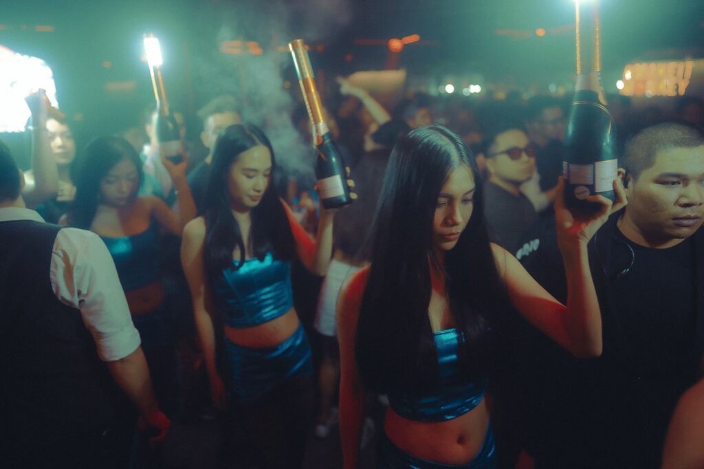 Energetic nightclub scene showcasing people enjoying a lively party atmosphere with champagne bottles.