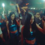 Energetic nightclub scene showcasing people enjoying a lively party atmosphere with champagne bottles.