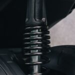 Detailed view of a motorcycle's suspension spring and metal components