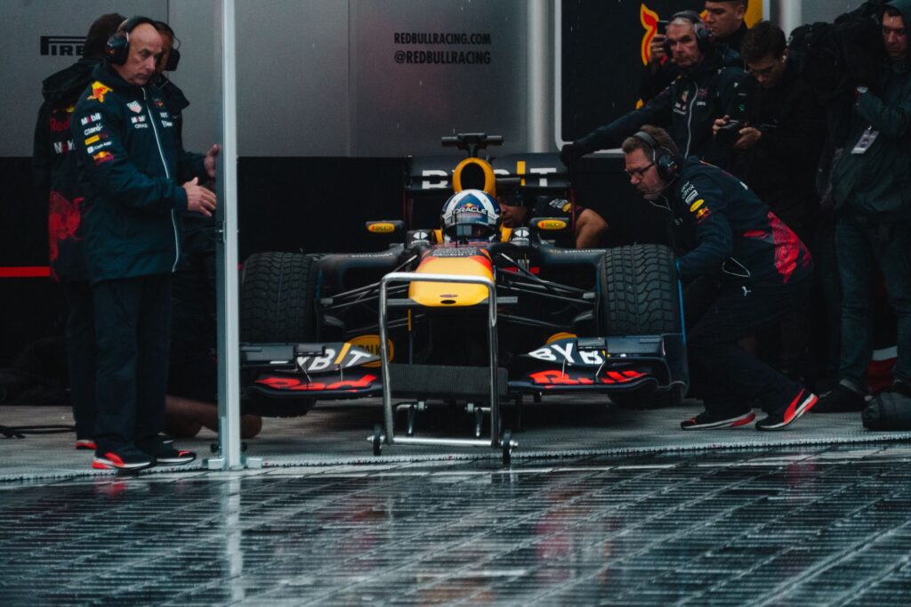 Red Bull Racing pit crew readying the Formula 1 car during an intense race event.