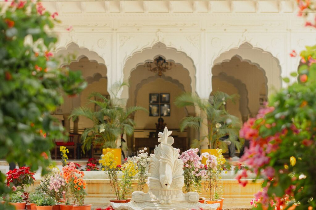 Charming floral arrangements in a historic palace courtyard creating a serene ambiance.